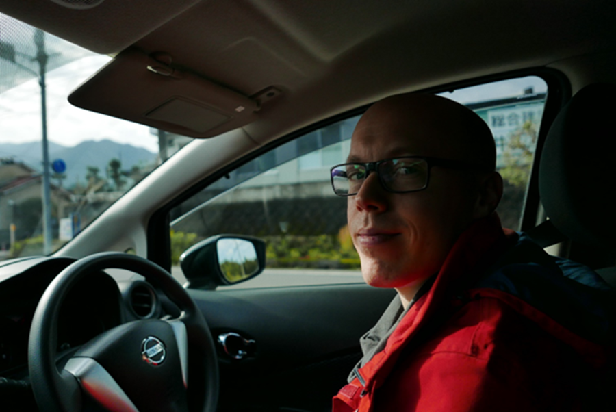 A technical writer sitting in a car